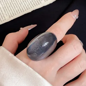 Oversized translucent blue resin ring with an irregular egg-shaped fashion design