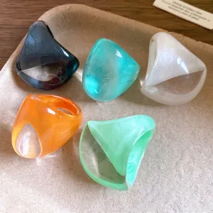 Set of 5 chunky irregular colorful resin rings with marble texture in a wide band design.