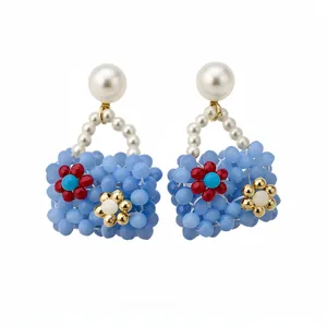 Cute blue beaded handbag earrings with pearl handle and floral details, sweet style.
