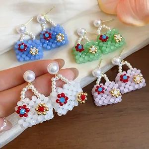 Handmade bag-shaped beaded earrings with pearls in various colorful dopamine styles.
