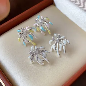 Macro view of elegant firework-inspired zircon earrings with colorful enamel finish