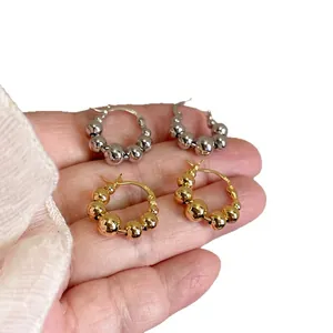 Minimalist shiny metallic beaded hoop earrings shown in both gold and silver finishes
