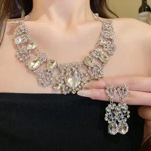 Close-up detail of an elegant rhinestone flower and waterdrop necklace and earrings set.