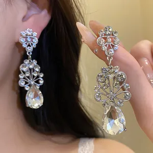 Elegant silver-tone flower drop earrings featuring sparkling water drop rhinestone detail
