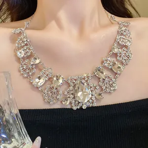 Elegant silver-tone necklace with ornate flower and teardrop crystal pendants for women.