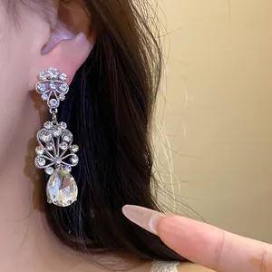 Close-up of rhinestone flower water drop earrings worn by model showing vintage style
