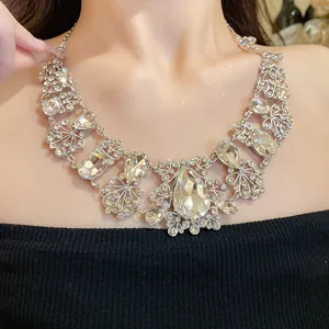 Close-up detail of a silver-toned rhinestone necklace featuring flower and teardrop pendants