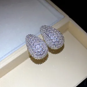 Macro detail of elegant teardrop stud earrings paved with sparkling clear cubic zirconia