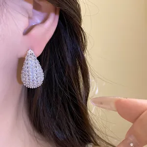 Close-up shot of elegant silver waterdrop earrings encrusted with sparkling zircons
