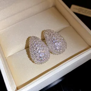 Close-up of sparkling cubic zirconia teardrop stud earrings in a luxury gift box