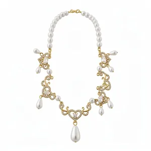Elegant vintage gold-toned pearl necklace with sparkling rhinestone heart and teardrop