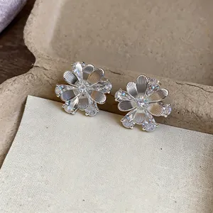 Detailed view of elegant silver flower stud earrings featuring sparkling zircon petals