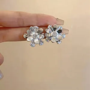 Detailed view of silver flower stud earrings featuring elegant zircon petal inlay