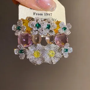 Boucles d'oreilles fleurs en argent et zircon avec cristaux jaunes et violets éclatants