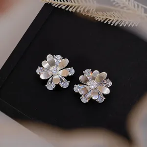 Detailed view of elegant silver needle zircon flower stud earrings with shimmering stones