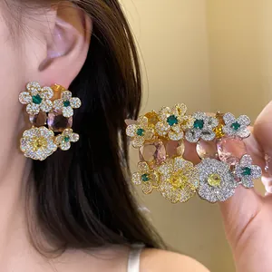 Vue macro détaillée d'élégantes boucles d'oreilles fleuries avec cristaux colorés