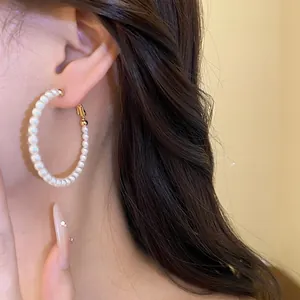 Detailed close-up of a French retro pearl beaded hoop earring with high lustrous finish