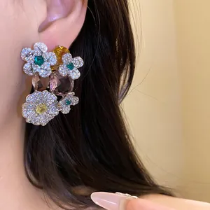 Gros plan détaillé de boucles d'oreilles fleurs en zircone de luxe avec pierres sur modèle