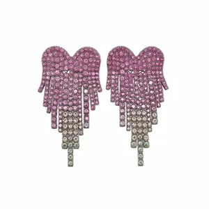 Elegant heart-shaped fringe earrings with pink gradient crystal pavé on white background