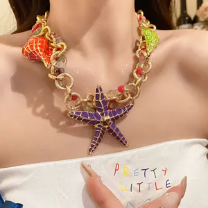 Macro view of a vibrant purple starfish and colorful shell necklace with gold chain.