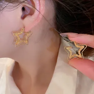 Elegant 18k gold plated star hoop earrings worn by a model in a luxury close-up view.