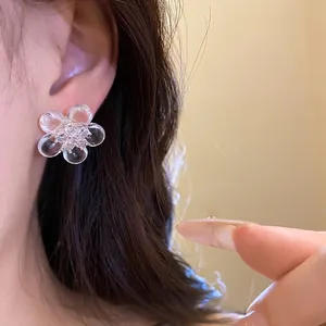 Elegant silver needle zircon resin flower stud earrings shown on ear for daily fashion