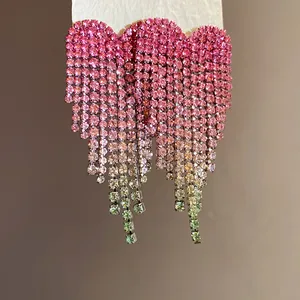 Sparkling heart-shaped rhinestone fringe earrings with pink to green gradient design.
