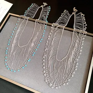 Close-up of crystal bead fringe necklaces in blue and clear styles on a display tray.