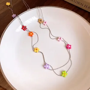 Vibrant colorful small flower layered necklace on a silver chain