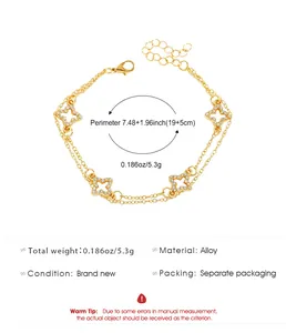 Bracelet double couche doré avec trèfles sertis de cristaux et détails des dimensions