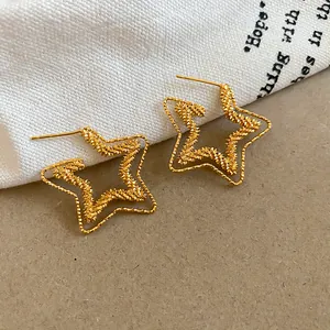 Detailed macro shot of 18k gold plated star stud earrings with textured surface design