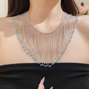Detailed view of a silver crystal bead fringe necklace with blue accents on a model.