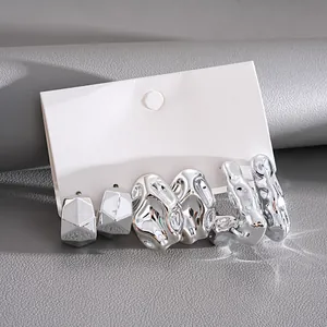 Close-up of 6-piece set of irregular silver metallic stud earrings on display card