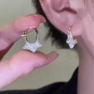 Close-up of sparkling star-shaped cubic zirconia hoop earrings for a stylish look.