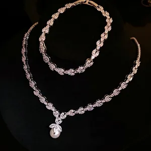 Elegant zircon and pearl jewelry set featuring a leaf-shaped necklace and matching bracelet