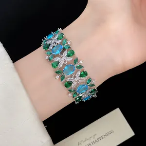 Detailaufnahme eines luxuriösen Zirkon-Blumenarmbands mit blauen und grünen Edelsteinen