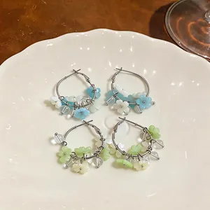Sweet vacation style hoop earrings with delicate blue and green resin flower charms.