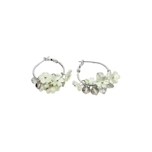 Elegant silver needle hoop earrings featuring delicate pale green resin flower charms