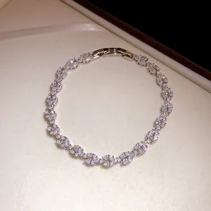 Close-up of elegant silver-tone leaf bracelet with sparkling marquise zircons in a jewelry box