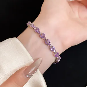 Close-up of elegant silver bracelet featuring marquise-cut purple zircons on a wrist