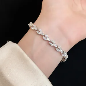 Close-up of a delicate silver-tone bracelet with marquise-cut stones on a wrist.