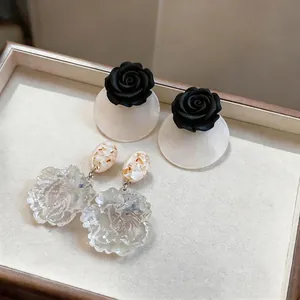 Handmade resin flower earrings and black rose studs for a vacation look
