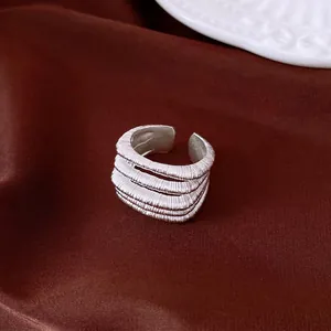 Vintage multi-layer textured silver open ring for women in elegant brown backdrop