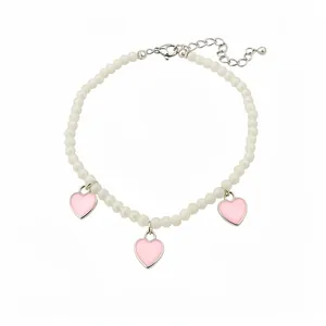 Elegant white beaded anklet featuring pink enamel heart charms and adjustable extender chain