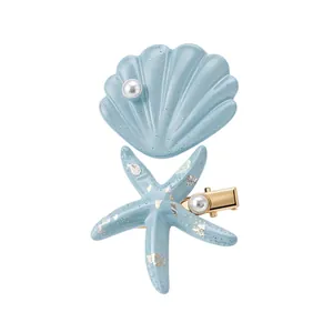 Blue resin starfish and shell hair clip set with pearls and gold flakes for beach style