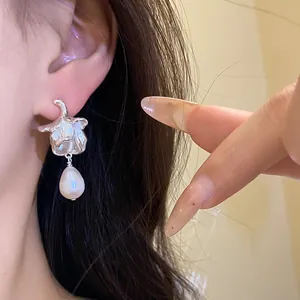 Detailed view of vintage flower earrings with elegant freshwater pearl drops