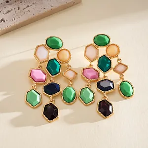 Detailed view of multi-colored geometric resin tassel earrings with gold-toned plating