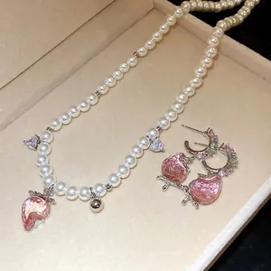 Elegant pearl necklace and matching earring set with pink crystal strawberry charms