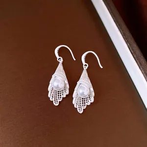 Elegant silver-toned hollow lace drop earrings featuring a lustrous white pearl