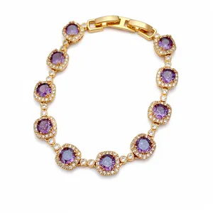 Vintage gold plated bracelet with purple cubic zirconia stones on white background